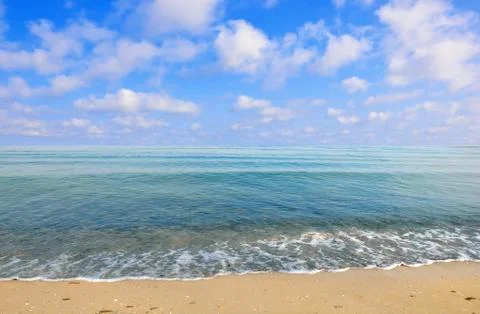 Black sea beach blue sky sand sun daylight Stock Photos