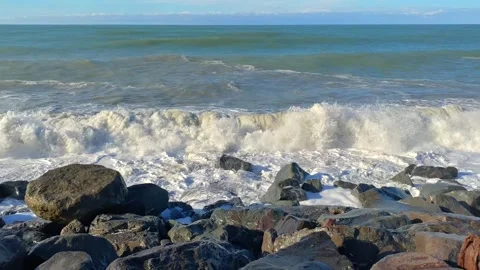 Black Sea waves breaking, shore-level view along a rocky Batumi coastline Stock Footage 345361588