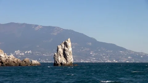 Black Sea waves of emerald color are broken on Sail rock. Stock Footage 106232255