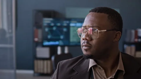 Black Security Engineer Looking at Camera while Working in Office Stock Footage 334931448