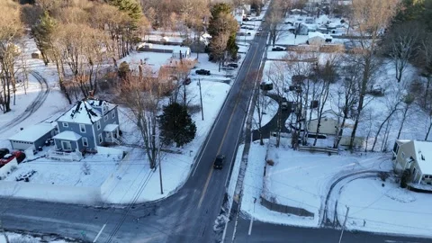 Black-sedan-turns-tracked-overhead-snowy-suburban-road-4k Stock Footage 296125663