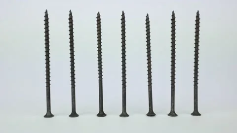 Black self-tapping screws on a white background. Detail for wood Stock Footage 232538203