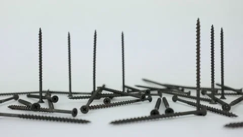 Black self-tapping screws on a white background. Detail for wood Stock Footage 232538212