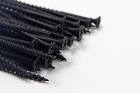 Black self-tapping screws on a white background. Self-tapping screws for wood.  Stock Photos