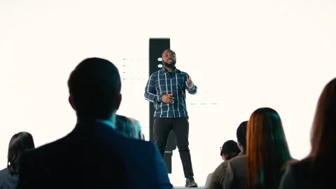 Black senior designer introduces new smartphone to participants Stock Footage 328263291
