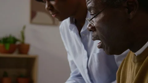 Black Senior Man Pressing Buttons on Laptop Keyboard Working with Bills Video stock 327685729