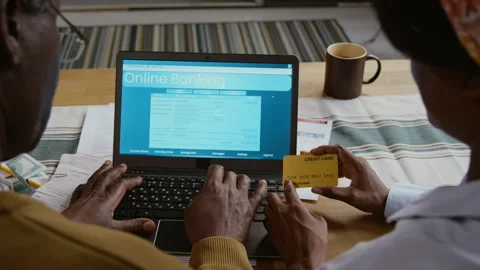Black Senior Man using Banking Website and Holding Credit Card Stock Footage 327685324