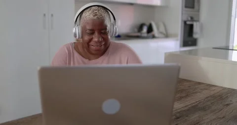 Black senior woman using on computer laptop at home Stock Footage 151680834