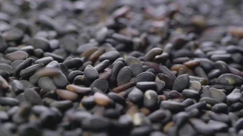 Black sesame seeds falling down. Slow motion. Stock Footage 243445896
