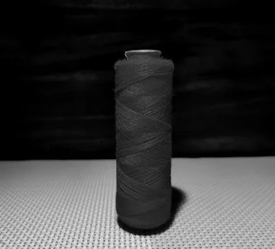 Black sewing thread with dark background. Foto stock