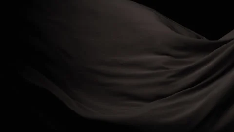 A Black Sheet Crinkles from the Right Side Against a Black Backdrop Stock Footage 270398393