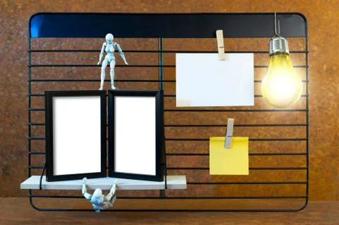 A black shelf in front of real rust. Two robots play and climb on the shelf. Stock Photos