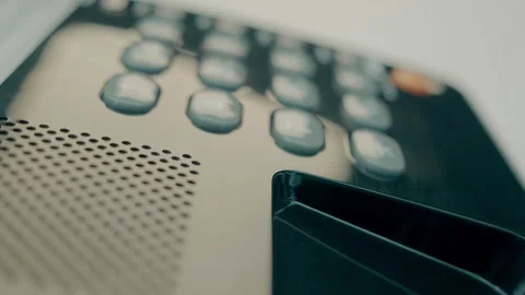 Black shiny push-button old telephone with the receiver removed and lying nearby Stock Footage 287949106