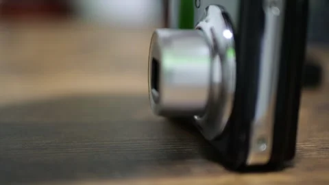 Black Shiny Retro Digital Camera Turning On with Mechanical Click and Lens Video stock 321528172