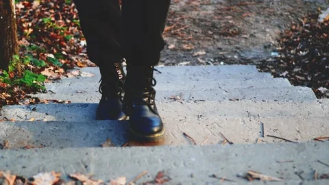 Black shoes walking on steps in the woods Stock Footage 221373889