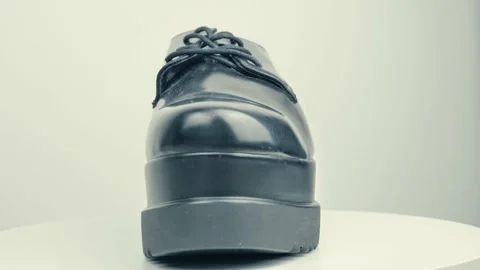 Black shoes on a white background, rotating on a turntable Stock Footage 220302851