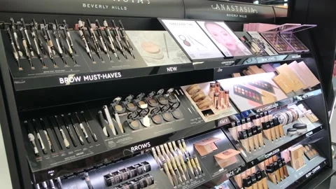 Black showcase of brow, face, eye cosmetic products in a beauty department in a Stock Footage 166819926