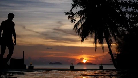 Black silhouette of a man against the backdrop of a beautiful sunset, sea and Video stock 95937294