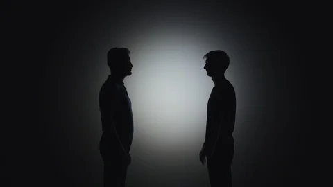Black silhouettes of men shake hands in a friendly manner Stock Footage 113996611