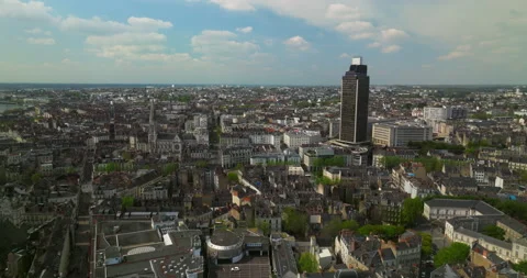 A black skyscraper against a blue sky was filmed from a drone in the city of Stock Footage 239482339