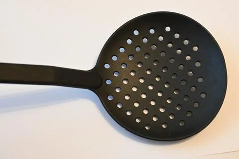 Black slotted spoon on a white background 스톡 사진