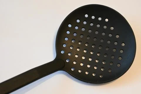 Black slotted spoon on a white background Stock-Fotos