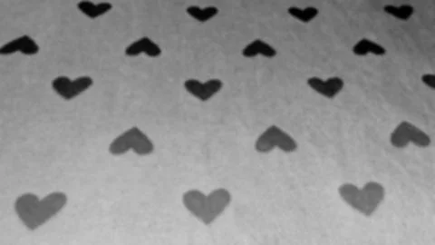 Black small hearts affect image. geometric seamless pattern, gray blur back Stock Photos