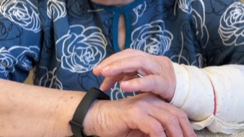The black smart band with display touchpad and heart rate monitor. The old woman Stock Footage 301339084