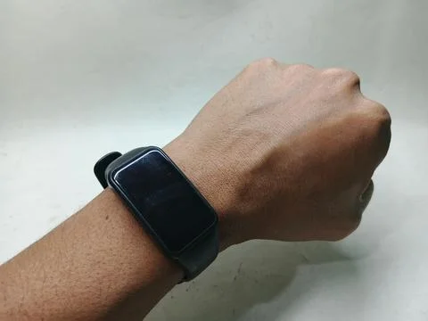Black smartband tracker on a wrist with turned off screen Stock Photos