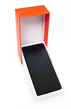 The black smartphone is in the box. Stock Photos