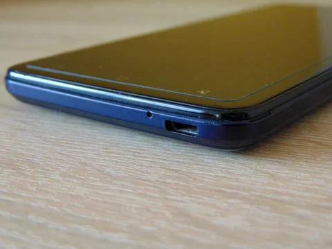 Black smartphone on a table Фото