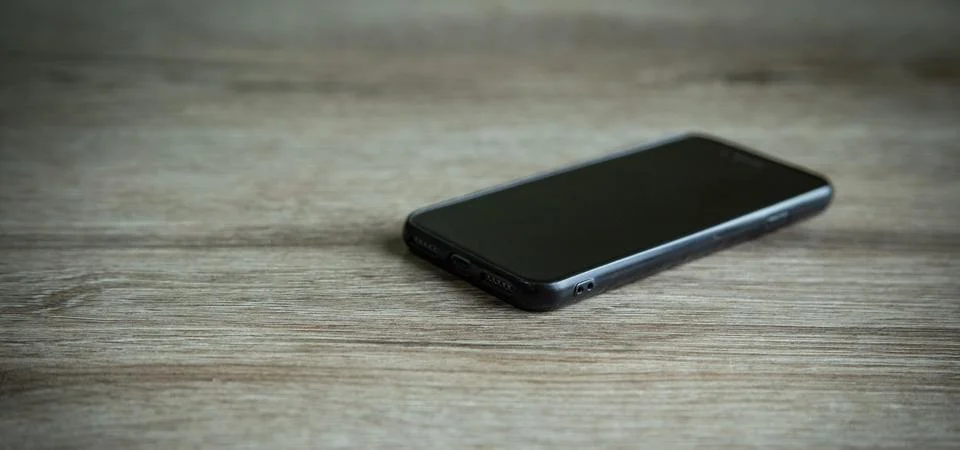 Black smartphone on the table. Technology Stock Photos