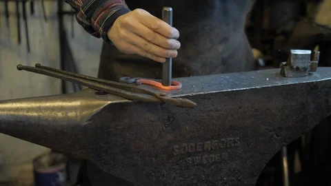 Black smith working in forge Stock Footage 104749157