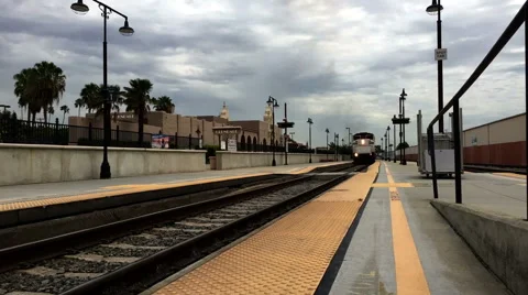 BLACK SMOKE AND APPROACHING TRAIN AT STATION Stock Footage 53375028