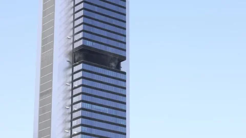 Black smoke and fire billowing from skyscraper window Stock Footage 337492379