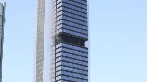 Black smoke and fire billowing from skyscraper windowI Stock Footage 337492398