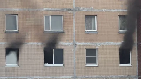 Black smoke billows from three windows of an apartment building Stock-Footage 199276170