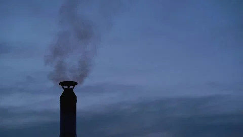 Black smoke comes out of a chimney against a dark blue sky Stock Footage 309752245