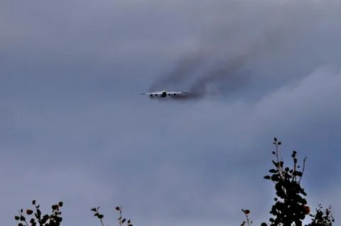 Black smoke from a four engine cargo plane Stock Photos