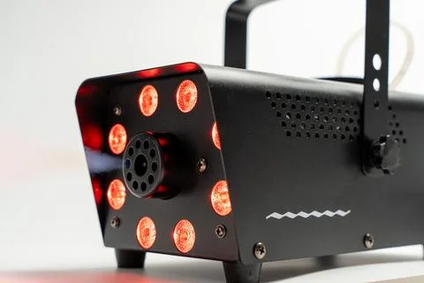 Black smoke machine with red lights. Stock Photos