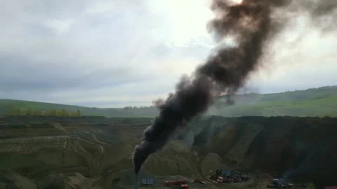 Black smoke rises from an open pit mine Stock Footage 331620096