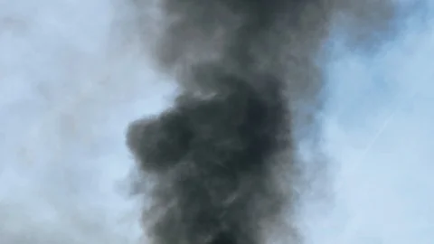 Black smoke rises in the sky. Slowmotion. Stock Footage 124668042