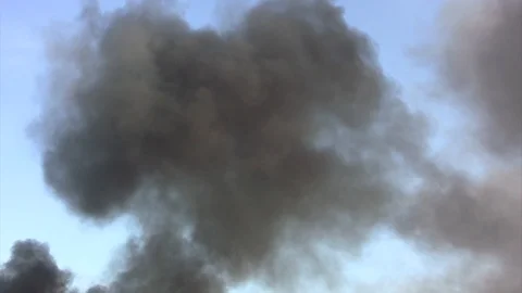 Black Smoke in sky tilt down to well fire Stock Footage 104805374