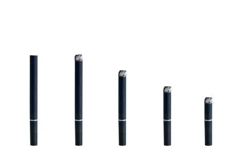Black smoldering cigarette of different sizes. White isolate Stock Photos