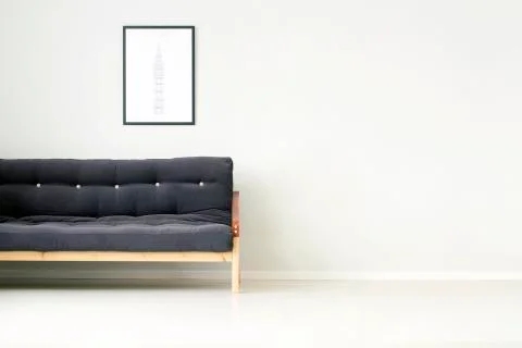 Black sofa against empty wall Stock Photos
