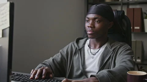 Black Software Developer Working on Computer and Thinking in Office Stock Footage 336710785