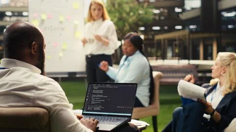 Black software developer working on programming code on laptop Stock Photos
