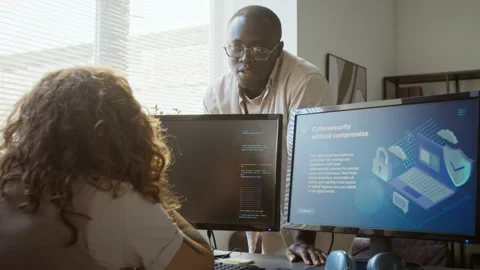 Black Software Engineer Explaining Cybersecurity to Colleague Stock Footage 348149843