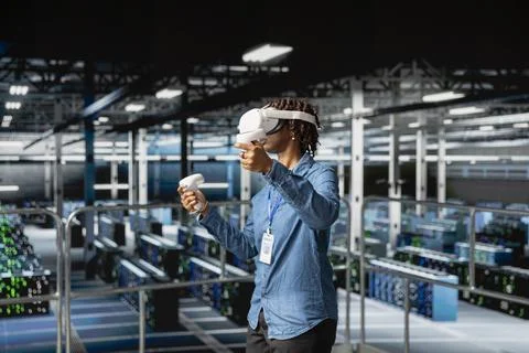 Black software engineer works with virtual reality tech on industrial platform 写真素材