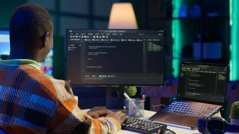 Black software engineer writes complex binary code scripts on computer Stock Photos